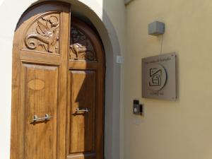 a wooden door in a building with a sign on it at A Family Tale - Una Storia Di Famiglia in Monterchi