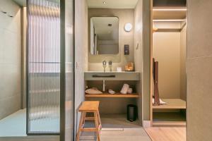a bathroom with a sink and a wooden stool at Andante Princesa in Barcelona +40 photos