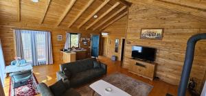 a living room with a couch and a flat screen tv at Bioland VILLA's in Novoberdo