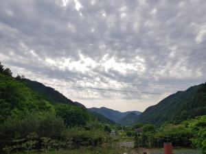 a view of a valley with mountains under a cloudy sky at Danyang Euljeon 56 Pension in Danyang