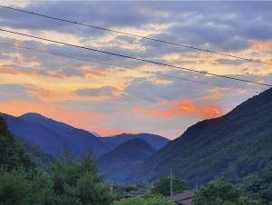 a view of a mountain range at sunset at Danyang Euljeon 56 Pension in Danyang