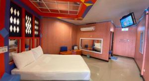 a bedroom with a bed and a tv in it at My House in Surin