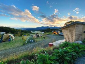 a group of tents in a field with a group of people at Base Camp Spring - Vacation STAY 35488v in Shibukawa
