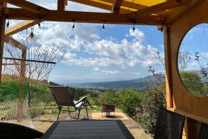 a patio with a chair and a view of the mountains at Base Camp Spring - Vacation STAY 35488v in Shibukawa +2 photos