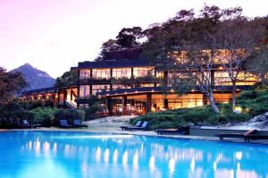 a building with a pool of water in front of it at A'lanka luxury hotel in haputale in Walhaputenna