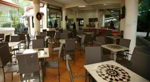 a room with tables and chairs in a building at Splash Oasis Resort & Hotel in Forestry +21 photos