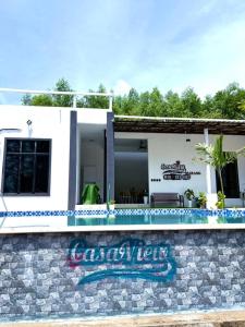 a house with a swimming pool in front of it at CasaView Island Marang in Marang