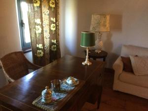a living room with a table with a lamp on it at Agriturismo la Torre in Argelato