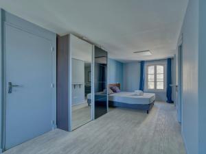 a blue room with a bed and a mirror at Maison de maître, Piscine privée, 4 suites in Nersac +54 photos