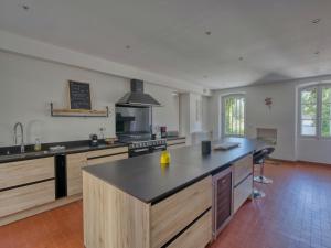 a large kitchen with a island in the middle at Maison de maître, Piscine privée, 4 suites in Nersac