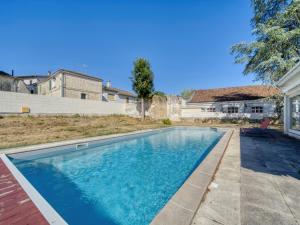 a swimming pool in the backyard of a house at Maison de maître, Piscine privée, 4 suites in Nersac