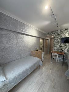 a bedroom with a bed and a desk in it at 7 Nebo in Almaty +25 photos