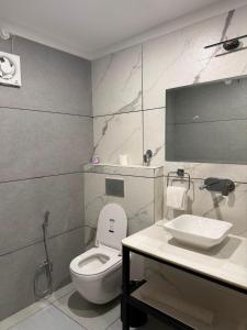 a bathroom with a toilet and a sink at Heritage Resort's Jageshwar in Jageshwar
