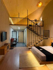 a bedroom with a staircase and a bed in a room at Heritage Resort's Jageshwar in Jageshwar