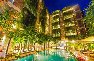 a swimming pool in the middle of a building at Mulberry Collection Silk Eco in Hoi An