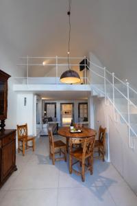a dining room with a wooden table and chairs at Cosmopolitan Suites - Small Luxury Hotels of the World in Fira