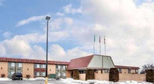 a building with flags on top of it in the snow at Quality Inn & Suites Okanogan - Omak in Okanogan