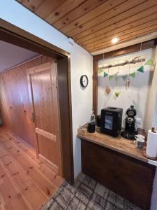 a room with a counter with a microwave and a door at Moosinest-Birkenzimmer in Schonach +3 photos