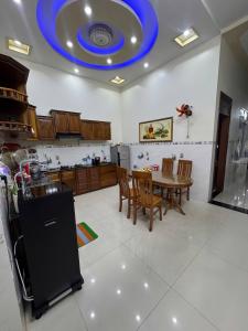 a kitchen with a table and a blue ceiling at Phú Hiệp Hotel in Thanh Xuân