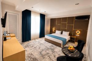 a hotel room with a bed and a table at Friday Old City Hotel in Tashkent +71 photos