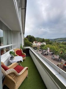 a balcony with chairs and tables and a view of a patio at Hotel Gästehaus Altena in Altena