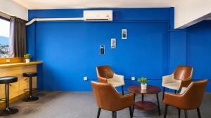 a waiting room with chairs and a blue wall at Destiny Hostel Pattaya in Jomtien Beach +15 photos