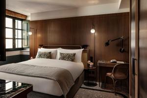 a hotel room with a bed and a desk at Romègas Hotel in Valletta