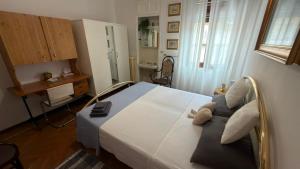 a bedroom with a bed with a teddy bear on it at Etoile Affittacamere in Saint Vincent