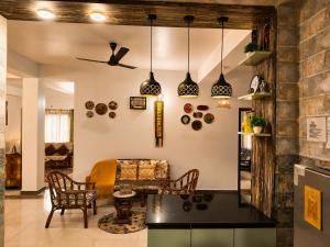 a living room with a table and chairs at Whispering Meadows Luxury 3BHK Villa in Shimla
