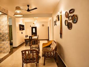 a living room with chairs and a dining room at Whispering Meadows Luxury 3BHK Villa in Shimla