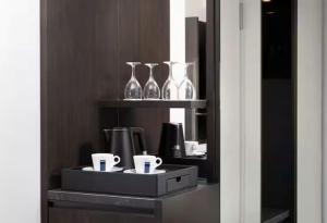 a shelf with glass vases and cups on it at Hilton Heidelberg in Heidelberg