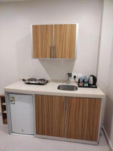 a small kitchen with a sink and a refrigerator at SPAR Serviced Apartments- سيبار للشقق المخدومة in Al Hofuf +23 photos