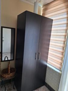 a large black cabinet in a room with a window at Dukii in Vrnjci