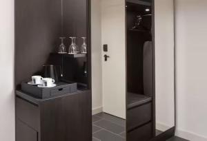 a small kitchen with a glass door and a counter at Hilton Heidelberg in Heidelberg