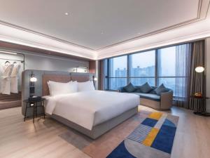 a bedroom with a large white bed and a couch at Mercure Lanzhou West in Lanzhou +54 photos