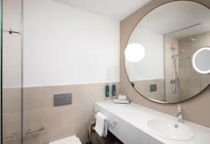 a bathroom with a sink and a mirror at Hilton Heidelberg in Heidelberg