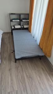 a bed in a room with a wooden floor at Gusturi din Livadă in Costeşti-Vîlsan +7 photos