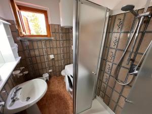 a small bathroom with a shower and a sink at Residence Delfini in Principina a Mare +26 photos