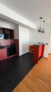 a kitchen with a counter and a table in a room at Apartmani Čarolija in Lučani +91 photos