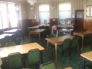 an empty dining room with tables and chairs at Royal Hotel in Blackpool