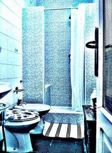 a bathroom with a toilet and a sink and a shower at I tre jack Malpensa in Case Nuove