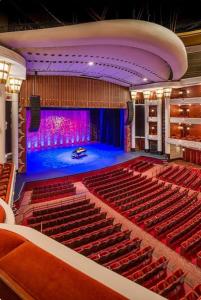 an empty auditorium with red seats and a stage at Perfect Family Group Getaway in West Palm Beach
