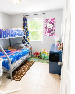 a bedroom with a bunk bed and a desk at Perfect Family Group Getaway in West Palm Beach +23 photos
