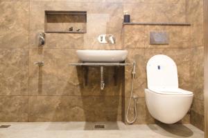 a bathroom with a toilet and a sink at Cliffs & Clouds in Bhīm Tāl +45 photos