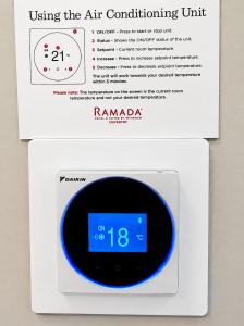 an alarm clock with the time on it at Ramada Hotel & Suites by Wyndham Coventry in Coventry