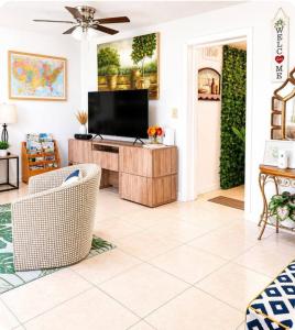 a living room with a flat screen tv on a wooden entertainment center at Perfect Family Group Getaway in West Palm Beach