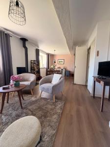 a living room with two chairs and a table at Chateau de Salorges - Farmgite in Corancy