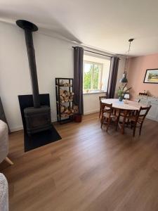 a living room with a wood stove and a table at Chateau de Salorges - Farmgite in Corancy
