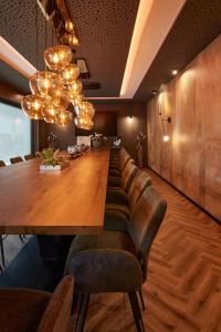 a dining room with a long table and leather chairs at Weingut und Gästehaus Apel in Nittel +107 photos