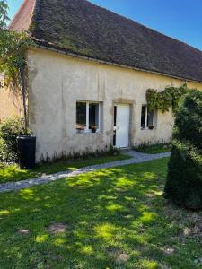 an old white house with a grass yard in front of it at Chateau de Salorges - Farmgite in Corancy